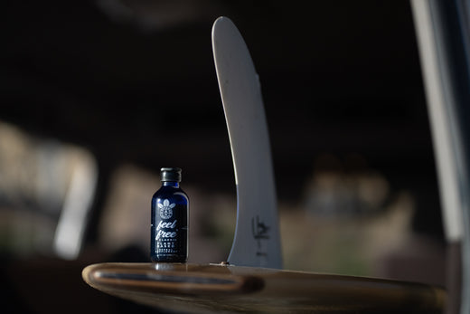 a bottle of feel free CLASSIC on a surf board